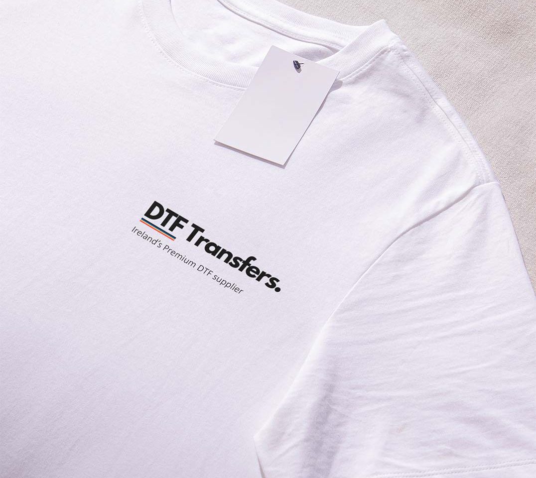 White shirt with 'DTF Transfers' logo prominently placed on the left breast, showcasing a clean and simple design.