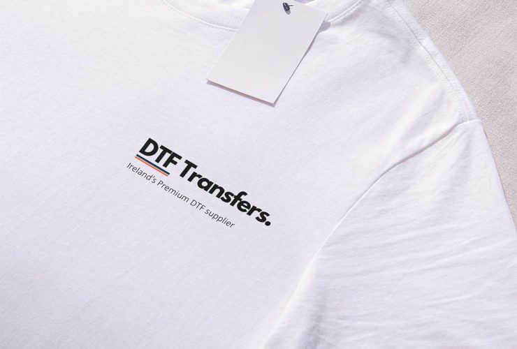 White shirt with 'DTF Transfers' logo prominently placed on the left breast, showcasing a clean and simple design.