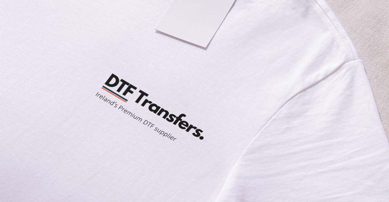 White shirt with 'DTF Transfers' logo prominently placed on the left breast, showcasing a clean and simple design.